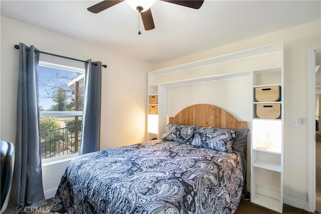 bedroom featuring ceiling fan and dark carpet