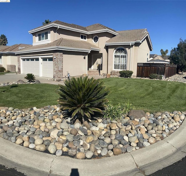 view of front of house with a front yard and a garage