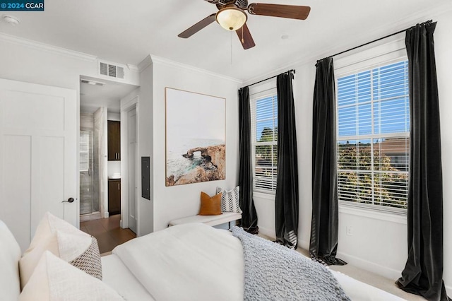 bedroom with ceiling fan, crown molding, and light hardwood / wood-style flooring