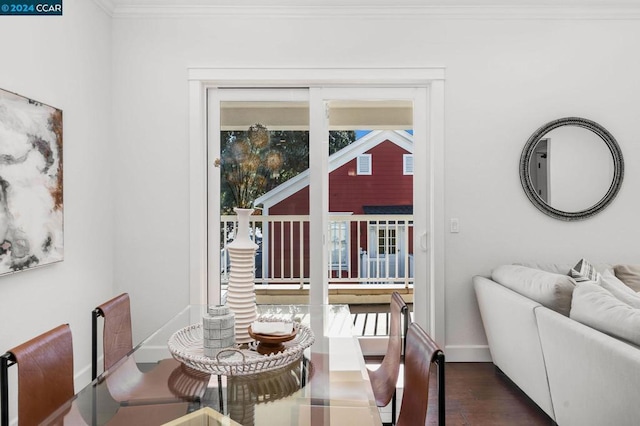 dining space featuring dark wood-type flooring and ornamental molding