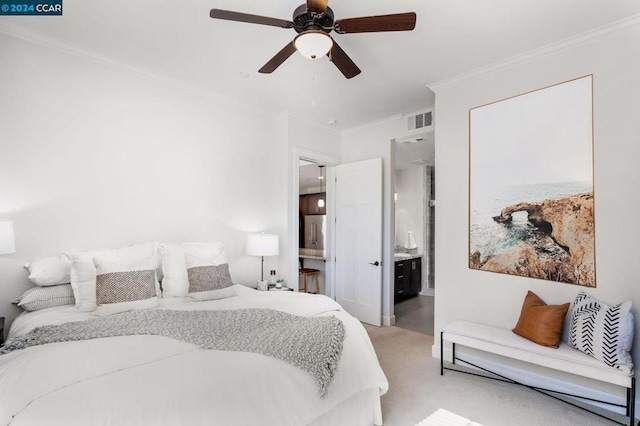 bedroom featuring ceiling fan, ornamental molding, light colored carpet, and ensuite bath