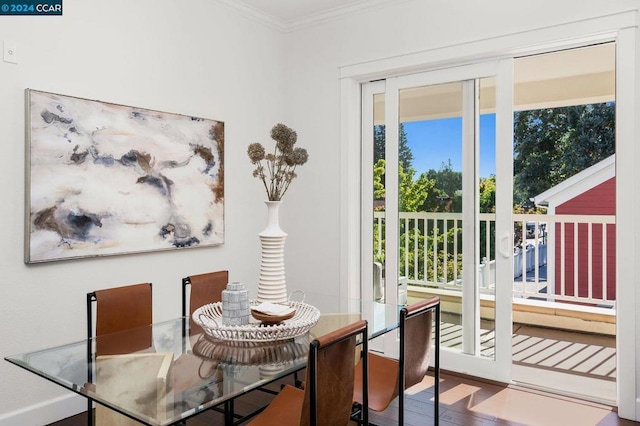 dining room featuring hardwood / wood-style flooring and crown molding