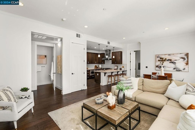 living room with dark hardwood / wood-style floors and crown molding