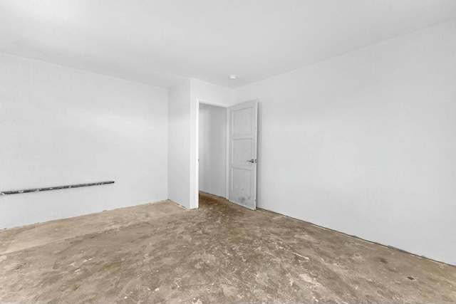 unfurnished room featuring concrete flooring