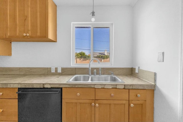 kitchen featuring sink, stainless steel dishwasher, and decorative light fixtures