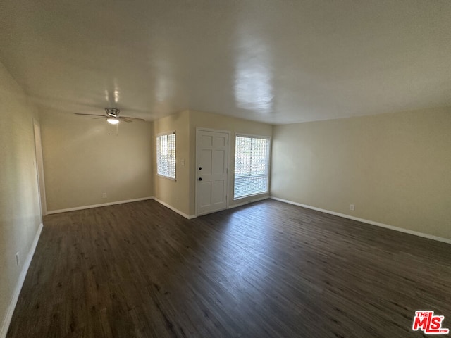 interior space featuring ceiling fan and dark hardwood / wood-style flooring