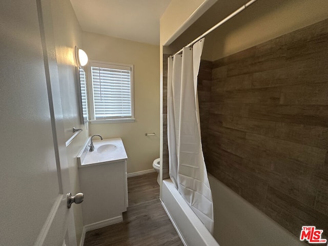 full bathroom with hardwood / wood-style flooring, vanity, toilet, and shower / bathtub combination with curtain