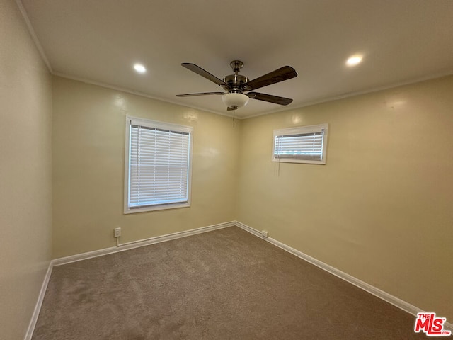 spare room with carpet flooring, ceiling fan, and crown molding