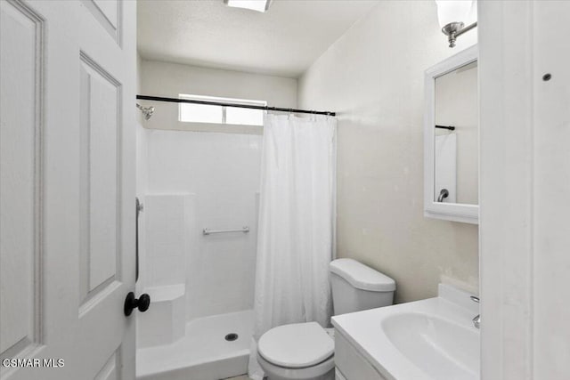 bathroom with a shower with curtain, vanity, and toilet