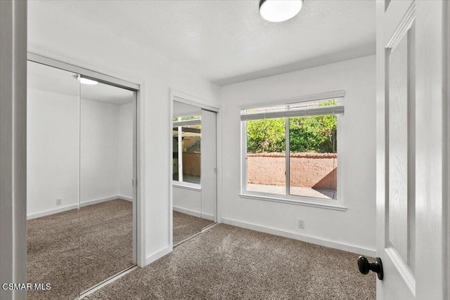 unfurnished bedroom featuring carpet floors and a textured ceiling