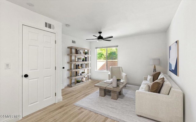 living room with ceiling fan and light wood-type flooring