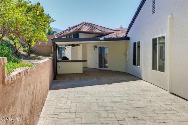 exterior space featuring a patio area and ceiling fan