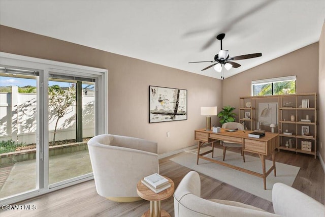 home office featuring wood-type flooring, vaulted ceiling, and ceiling fan