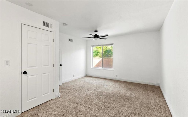 empty room with carpet and ceiling fan