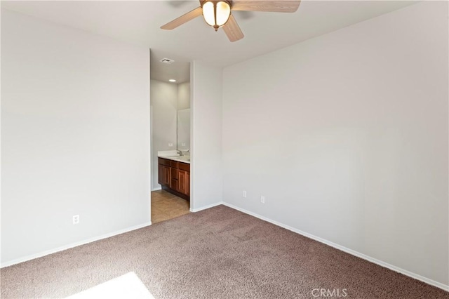 unfurnished room with ceiling fan and light colored carpet