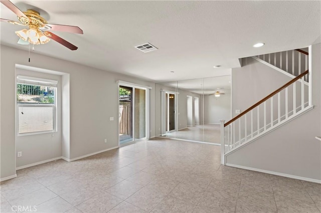 unfurnished room with light tile patterned floors and ceiling fan