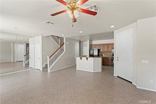 unfurnished living room with ceiling fan