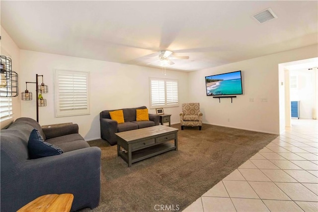 living room with ceiling fan and light tile patterned flooring