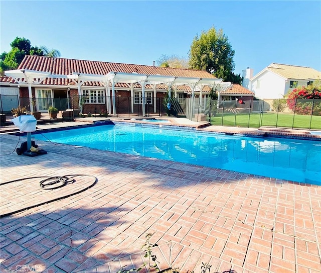 view of swimming pool featuring an in ground hot tub and a patio