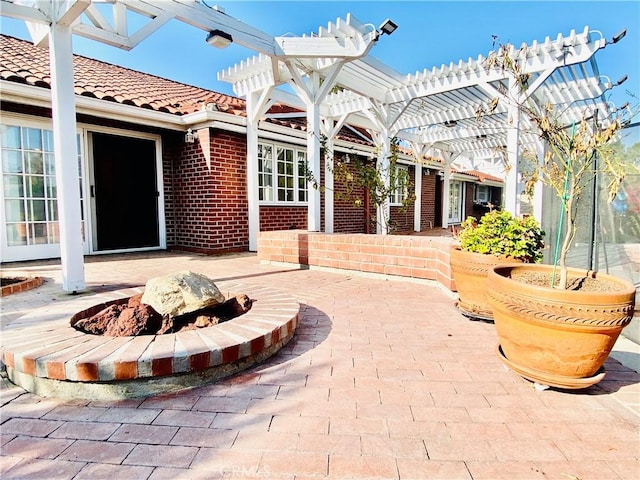 view of patio featuring a pergola and a fire pit