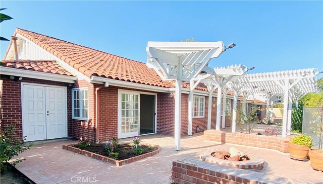 view of patio with a fire pit and a pergola