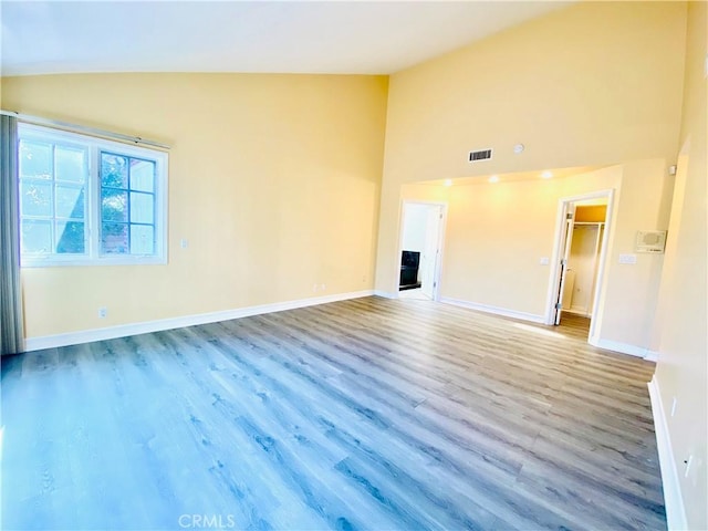 unfurnished living room featuring light wood-type flooring and lofted ceiling