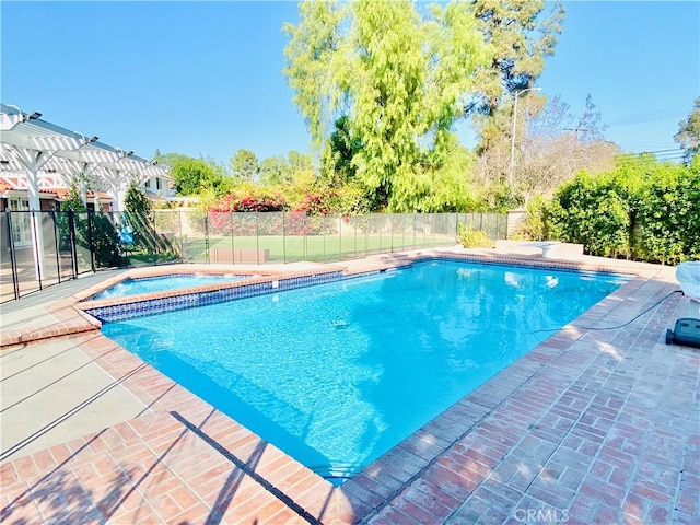 view of pool with an in ground hot tub