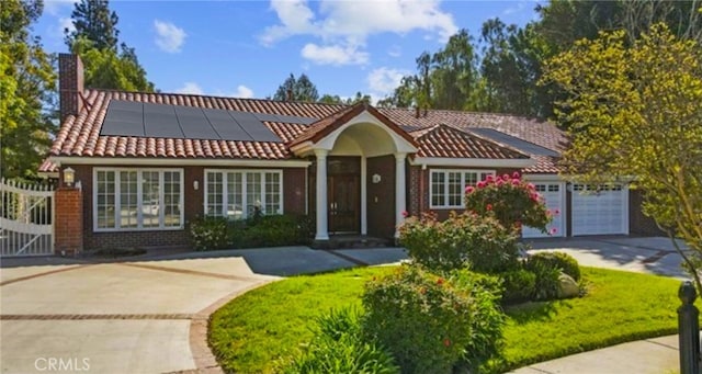 view of front of home with a garage and solar panels