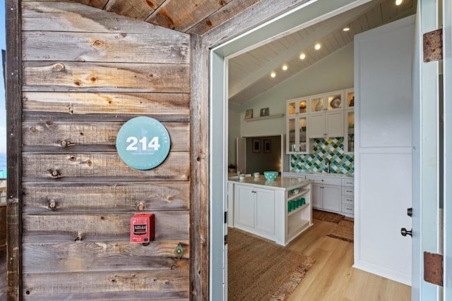 interior details featuring tasteful backsplash and hardwood / wood-style flooring