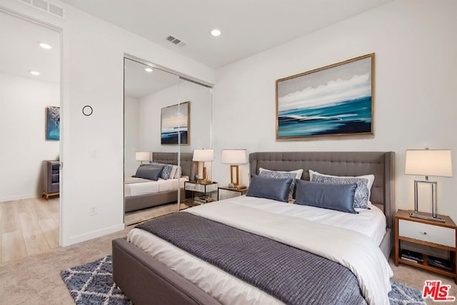 bedroom featuring a closet and light hardwood / wood-style flooring