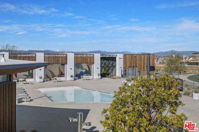 view of swimming pool with a mountain view, a gazebo, and a patio