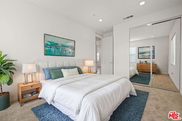 carpeted bedroom with a closet