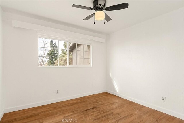 unfurnished room with ceiling fan and wood-type flooring