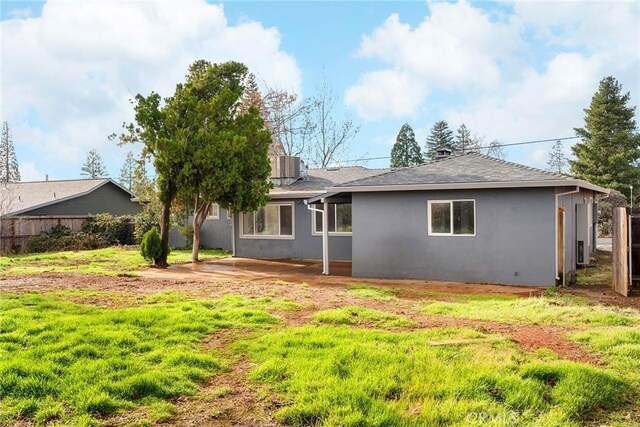 5690 Paradise Ave, Paradise, CA 95969 - rear view of property featuring stucco siding, fence, central air condition unit, and roof with shingles