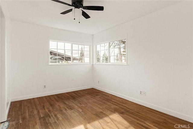 spare room with hardwood / wood-style flooring and ceiling fan