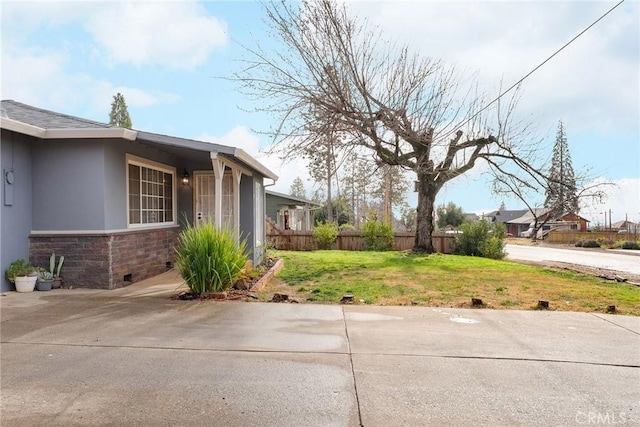 view of side of home with a lawn