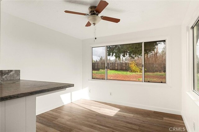 5690 Paradise Ave, Paradise, CA 95969 - unfurnished dining area with wood finished floors, ceiling fan, and baseboards