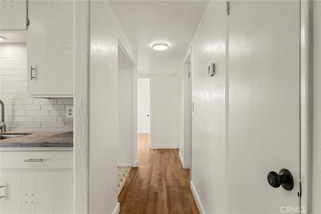 hall featuring sink and wood-type flooring