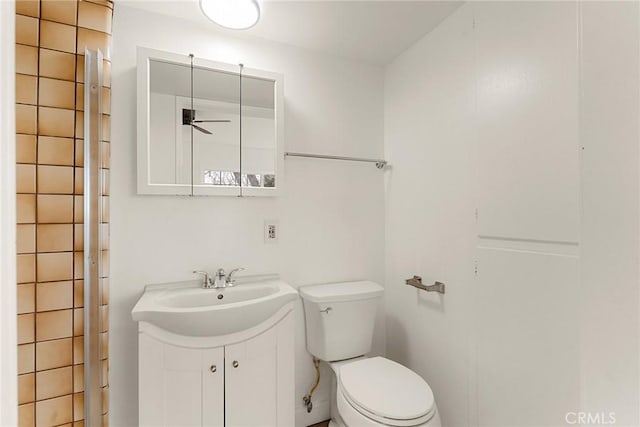 bathroom featuring ceiling fan, toilet, and vanity