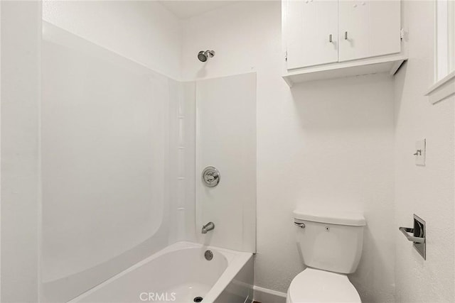 bathroom featuring toilet and bathing tub / shower combination