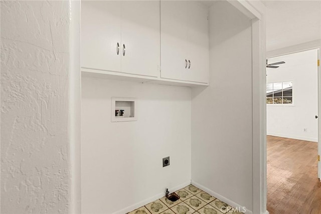 clothes washing area featuring ceiling fan, washer hookup, cabinets, hookup for an electric dryer, and light hardwood / wood-style floors