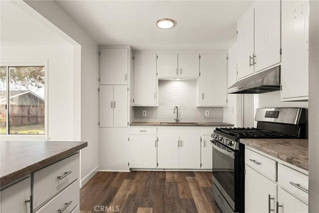 5690 Paradise Ave, Paradise, CA 95969 - kitchen featuring stainless steel gas stove, under cabinet range hood, a sink, backsplash, and dark wood-type flooring