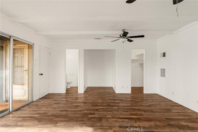 spare room featuring beam ceiling, dark hardwood / wood-style floors, and ceiling fan