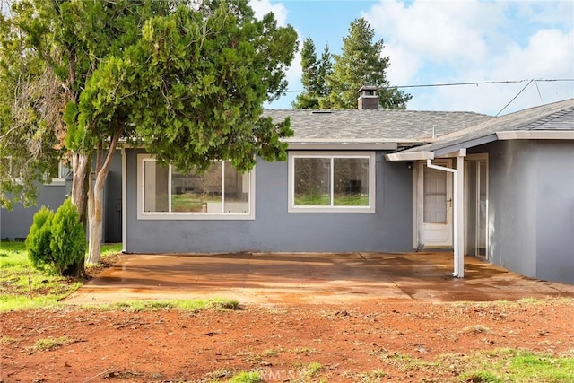 5690 Paradise Ave, Paradise, CA 95969 - view of front facade featuring stucco siding, a chimney, and a shingled roof