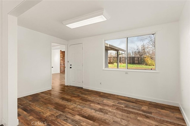 spare room with dark hardwood / wood-style floors