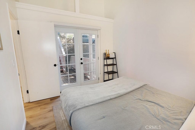 bedroom featuring hardwood / wood-style flooring, access to exterior, and french doors