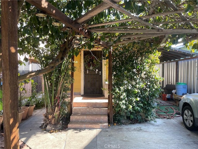 property entrance featuring a pergola