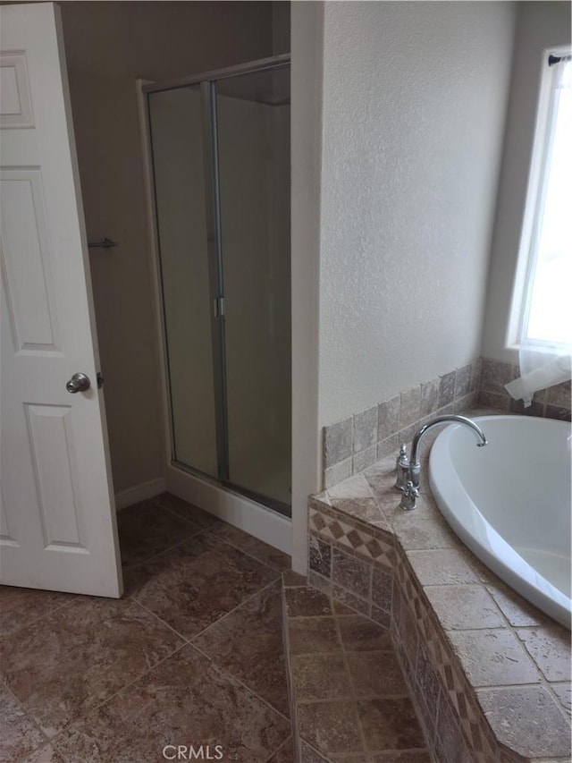 bathroom featuring plus walk in shower