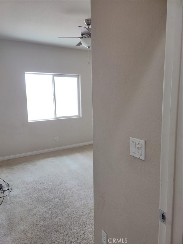 empty room with carpet floors and ceiling fan