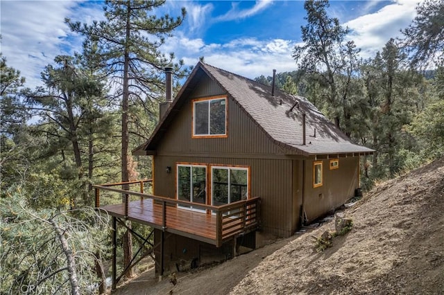 back of property featuring a wooden deck